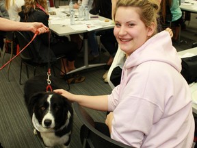 North Lambton Secondary School student Hailey Bayne-Foster pets a working dog from St. John Ambulance's Therapy Dog Program. Around 25 grade 12 students from Forest and Petrolia participated in a day-long seminar for the Health and Wellness Specialist High Skills Major program. 
CARL HNATYSHYN/SARNIA THIS WEEK