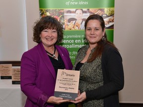 Sandra Carther (right) receives the Premier's Award for Agri-Food Innovation Excellence from MPP Kathryn McGarry.