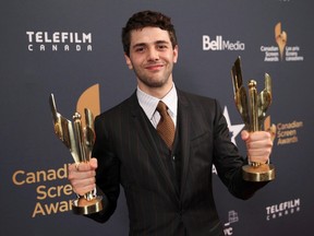 Xavier Dolan holds best director and best film awards for "Mommy" backstage at the 2015 Canadian Screen Awards in Toronto, March 1, 2015.  REUTERS/Fred Thornhill