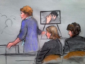 Assistant U.S. Attorney Nadine Pellegrini (standing) speaks during the sentencing phase of the murder trial of Dzhokhar Tsarnaev, as Tsarnaev is seen gesturing in a photograph, in a courtroom sketch in Boston April 21, 2015. REUTERS/Jane Collins