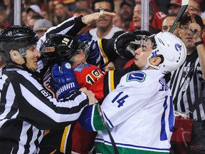 David Jones #19 of the Calgary Flames mixes it up with Alex Burrows #14 of the Vancouver Canucks in Game Three of the Western Quarterfinals during the 2015 NHL Stanley Cup Playoffs at Scotiabank Saddledome on April 19, 2015 in Calgary, Alberta, Canada. (Derek Leung/Getty Images/AFP)