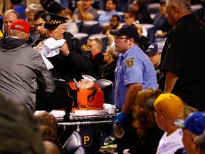 A woman seated in the Lexus Club section of PNC Park is taken out by EMTs on a stretcher after taking a foul ball to the back of her head in the second inning during the game between the Pittsburgh Pirates and the Chicago Cubs on April 20, 2015 in Pittsburgh. (Jared Wickerham/Getty Images/AFP)