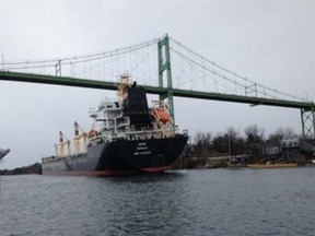 The motor vessel Juno, a 621-foot bulk carrier, sits aground under the Thousand Islands Bridge, April 20, 2015. The vessel ran hard aground after suffering a steering casualty. (U.S. Coast Guard photo)