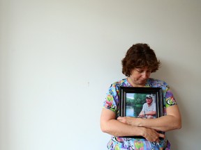 Vicky Jackson with a photograph of her best friend, the late Doug Christie, at Belleville General Hospital in Belleville, Ont. Tuesday April 21, 2015. Christie, 51, of Bayside, Ont. died March 15 and his donated lungs and eyes have helped three people through transplants. Jackson's employer, Quinte Health Care, is running a workplace campaign to help boost registration of potential donors.