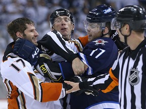 Anaheim Ducks centre Ryan Kesler (left) smiles as he tussles with Winnipeg Jets centre Adam Lowry in NHL playoff action at MTS Centre in Winnipeg, Man., on Mon., April 20, 2015. Kevin King/Winnipeg Sun/Postmedia Network
