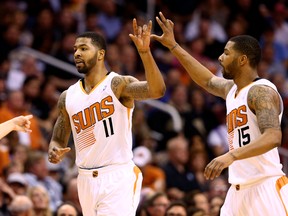 Phoenix Suns forward Markieff Morris (left) celebrates a play with twin brother Marcus against the Indiana Pacers at US Airways Center. (Mark J. Rebilas/USA TODAY Sports)