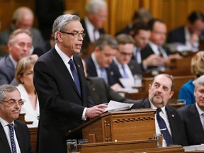 Canada's Finance Minister Joe Oliver speaks about the federal budget in the House of Commons, as Prime Minister Stephen Harper listens (R) on Parliament Hill in Ottawa April 21, 2015. REUTERS/Chris Wattie