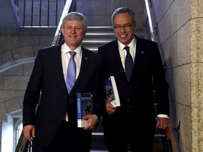 Prime Minister Stephen Harper (L) and Finance Minister Joe Oliver walk to the House of Commons to deliver the federal budget on Parliament Hill in Ottawa April 21, 2015. REUTERS/Patrick Doyle