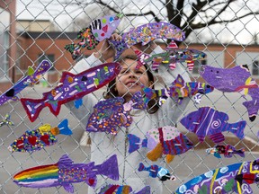 Nine-year-old Sammantha Burtch Santelli is one of the more than 700 students and staff to paint a wooden fish at Princess Elizabeth Public School in London, Ont. on Tuesday April 21, 2015.  (DEREK RUTTAN, The London Free Press)