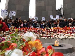 People lay flowers at the Tsitsernakaberd Armenian Genocide Memorial in Yerevan on April 21,2015. (AFP PHOTO/KAREN MINASYAN)
