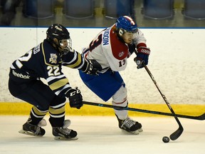Kingston Voyageurs' Joey Beaudoin makes a move past Toronto Patriots' Louis DiMatteo during Game 6 of the Ontario Junior Hockey League Buckland Cup final at the Invista Centre on Monday. The Voyageurs won 3-1 to force a Game 7 Wednesday night in Toronto. (James Paddle-Grant/For The Whig-Standard)