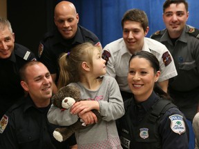 Madeleine Frechette (5) waits to meet her heroes at the Gatineau police head quarters in Gatineau Tuesday, April 21, 2015. On Feb. 15, police, firefighters and paramedics took turns giving CPR to Madeleine during a emergency call which saved her life. Madeleine and her family got a chance to thank all involved in saving her life Tuesday.  Tony Caldwell/Postmedia Network