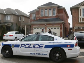 Peel Regional Police at a home in Brampton on Tuesday April 21, 2015 after a 21-month-old girl was found dead the night before. (Stan Behal/Toronto Sun)