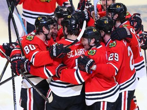 Chicago Blackhawks defenceman Brent Seabrook is congratulated for scoring the winning goal during the third overtime period against the Nashville Predators in Game 4 of the first round of the 2015 NHL playoffs at the United Center on April 22, 2015. (Dennis Wierzbicki/USA TODAY Sports)