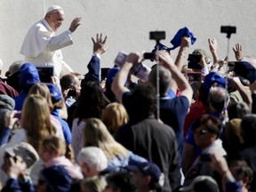 Pope Francis waves as he arrives to lead the weekly audience in Saint Peter's Square at the Vatican on April 22, 2015.   REUTERS/Max Rossi