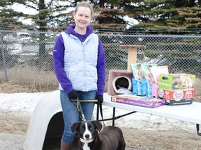 Northern Ontario Animal Welfare Society volunteer Erica Arsenault poses with 1-year-old northern mix dog Annika during NOAWS Time To Shine charity carwash fundraiser on Saturday April 18th. NOAWS held the fundraiser to raise funds and ask for donations such as pet food, litter, and other pet related items. Annika is available for adoption.