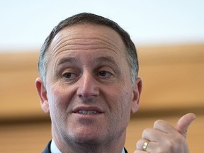 This file photo taken on Aug. 20, 2014, shows New Zealand Prime Minister John Key speaking to students in Masterton during an election campaign. (AFP PHOTO/FILES/MARTY MELVILLE)