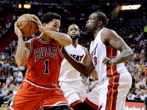 Chicago Bulls guard Derrick Rose (1) is defended by Miami Heat forward Luol Deng (9) during the first half at American Airlines Arena. (Steve Mitchell-USA TODAY Sports)