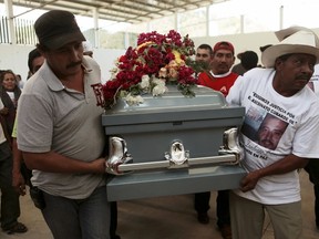 Relatives of Antonio Zambrano-Montes carry his coffin after a funeral mass in Pomaro, in the Mexican state of Michoacan in this March 7, 2015 file photo. REUTERS/Alan Ortega/Files