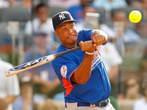 Former MLB player Bernie Williams hits a home run during the Legends and Celebrities All-Star softball game at Citi Field in New York, July 14, 2013. (REUTERS/Adam Hunger)