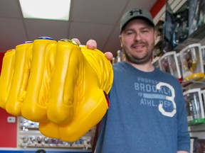 Tim Miller/The Intelligencer 
Quinte ToyCon event organizer Trevor Smalldon shows off an Infinity Gauntlet piggy bank at Need A Hero? Comics in Belleville. Smalldon is expecting the first Quinte ToyCon to be the largest of its type the area has seen.