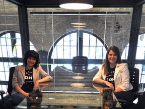 Ellipsis Digital employees Rachel Berdan, VP customer engagement (left), and Karen Schulman Dupuis, VP business design, sit at their railway-inspired conference table in London Ont. April 22, 2015. Ellipsis Digital opened up their renovated space in the historic London Roundhouse to the public that day. CHRIS MONTANINI\LONDONER\POSTMEDIA NETWORK