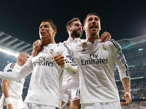 Cristiano Ronaldo, Sergio Ramos and Dani Carvajal celebrate after a goal for Real Madrid in their 1-0 win over Atletico Madrid in Champions League quarterfinal play Wednesday at the Bernabeu stadium. (Reuters/Juan Medina)