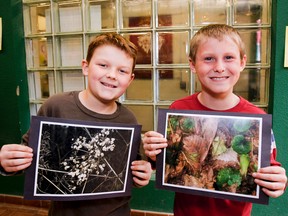 J.J. O'Neill Catholic School Grade 3 students, Blake Dowling, left, and Karter Brett hold up their nationally recognized photos in Napanee. Dowling won the Elementary Challenge and Brett received an honourable mention as part of the fall 2014 Roberta Bondar School Challenge. (Julia McKay/The Whig-Standard)