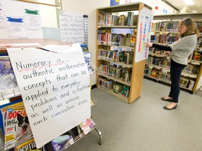 Woodland Heights Public School teacher Lisa Clarke looks through solutions to introduce numeracy to various subjects as the teachers become the students during learning exercises on a PD Day at the Springbank Drive school in London, Ont. on Friday April 17, 2015. 
(CRAIG GLOVER, The London Free Press)