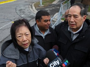 Winnie Woo and her husband Raymond visit the scene of the blast site in Scarborough Wednesday, Aprili 22, 2015, two days after fleeing from their home which backs onto the house that was levelled in the explosion. (CHRIS DOUCETTE/TORONTO SUN)