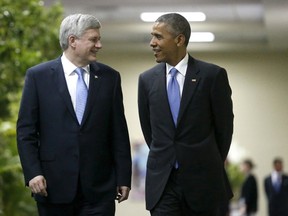 U.S. President Barack Obama (R) walks with Canada's Prime Minister Stephen Harper to a bilateral meeting during the first plenary session of the Summit of the Americas in Panama City April 11, 2015. REUTERS/Jonathan Ernst