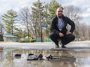 Dan Moscato shows one of the puddles he says could be easily fixed without having to build runoffs throughout the area.  (Joel Watson/Ottawa Sun/PostMedia Network)