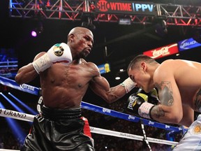 Floyd Mayweather Jr. (left) punches Marcos Maidana during their WBC/WBA welterweight unification fight at the MGM Grand Garden Arena in Las Vegas, Nevada, May 3, 2014. (REUTERS/Steve Marcus)