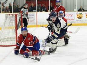 Mike Crocock (18) of the Kingston Voyageurs battles for the puck with Mitchell Emerson  of the Toronto Patriots during the first period of Game 7 of the Ontario Junior Hockey League championship series in Toronto on Wednesday night. The Patriots won the game 6-1. (Tim Bates/OJHL Images)