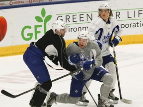 Connor Brown is caught between Petter Granberg (left) and William Nylander at Marlies practice on Wednesday. (Veronica Henri/Toronto Sun)