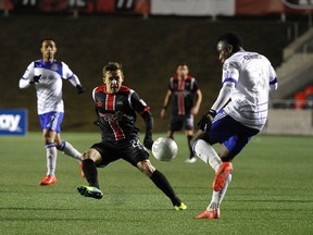 Ottawa Fury midfielder, Patryk Misik, tries to block the pass from Edmonton defenceman Eddie Edward in Ottawa on Wednesday. Edmonton won the Amway Championship preliminary match 3-1.