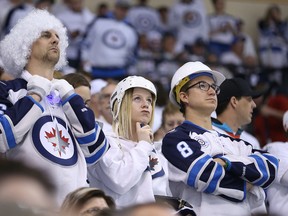 Winnipeg Jets fans look on late in the third period of a 5-2 loss to the Anaheim Ducks during NHL playoff action in Winnipeg on Wed., April 22, 2015. Kevin King/Winnipeg Sun/Postmedia Network