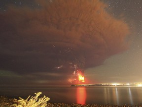 Smoke and lava spew from the Calbuco volcano, as seen from the shores of Lake Llanquihue in Puerto Varas, April 23, 2015. The Calbuco volcano in southern Chile erupted for the first time in more than five decades on Wednesday, sending a thick plume of ash and smoke several kilometres into the sky. REUTERS/Carlos Gutierrez