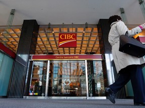 A pedestrian walks past a main branch of CIBC in  Montreal, April 24, 2014. (REUTERS/Christinne Muschi)