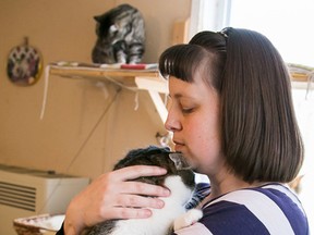 TIM MILLER/THE INTELLIGENCER
Kendra Casey snuggles with a cat at the Loyalist Humane Society in Prince Edward County, where the volunteers, on Thursday. Casey's eight year old son, Christopher, was instrumental in setting up a Fill the Truck fundraiser for the shelter, which took place on Saturday at the Walmart in Trenton.