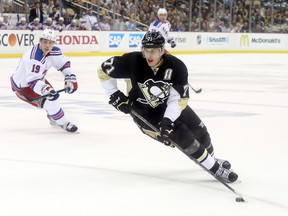Pittsburgh Penguins center Evgeni Malkin skates with the puck against the New York Rangers during Game 3 of the first round of the 2015 NHL playoffs at the CONSOL Energy Center on April 20, 2015. (Charles LeClaire/USA TODAY Sports)