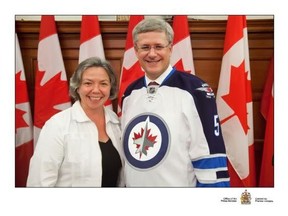 Harper, however, may just have a Jets jersey laying around somewhere. A photo on Conservative MP Joyce Bateman's website shows Bateman and Harper together with Harper wearing the Jets' white version.