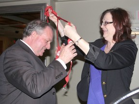 Mike Ryan, the regional deputy commissioner for the Ontario region of the Correctional Service of Canada, is the new chair for the annual United Way campaign. He received the red suspenders, the traditional garb for the role, from past-chair Carrie Batt during a workplace campaign awards luncheon. (Michael Lea/The Whig-Standard)