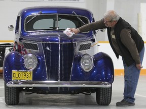 Dick Brasher of the Manitoba Street Rod Association polishes a 1937 Ford in Winnipeg, Man. Thursday April 23, 2015. The car, which has been named street rod of the year, will be seen at the annual MSRA Rodarama this weekend.