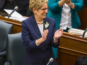 Ontario Premier Kathleen Wynne applauds after Finance Minister Charles Sousa presented the 2015 Ontario Budget at Queen's Park on Thursday, April 23, 2015. (ERNEST DOROSZUK/Toronto Sun)