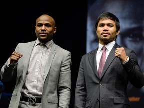 Floyd Mayweather (left) and Manny Pacquiao pose for photographers during a press conference to announce their fight on May 2, 2015 at Los Angeles. (Robert Hanashiro/USA TODAY Sports)
