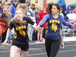 East Northumberland Blue Dragons' Katie Falla passes the baton to Tori MacNeil in the open girls' medley relay during Wednesday's annual Bay of Quinte Relay Carnival at ENSS's new track and field facility in Brighton. (Tim Meeks/The Intelligencer)