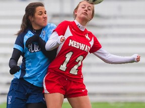 Lucas?s Nicole Micallef fights for a bouncing ball with Medway?s Connie Girling during their TVRA Central season opener at Western?s Huron East field on Thursday. (MIKE HENSEN, The London Free Press)