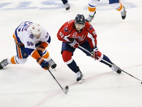 Washington Capitals centre Evgeny Kuznetsov skates with the puck around New York Islanders defenceman Johnny Boychuk en route to scoring a goal in the third period in Game 5 of the first round of the 2015 NHL playoffs at Verizon Center on April 23, 2015. (Geoff Burke/USA TODAY Sports)