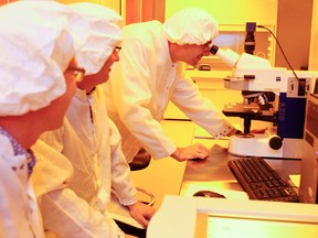 Researchers and Queen's University faculty Richard Oleschuk, left, Graham Gibson, and Rob Knobel check out some of the equipment in the clean room of the new Kingston Nano-Fabrication Laboratory located in Innovation Park. (Julia McKay/The Whig-Standard)